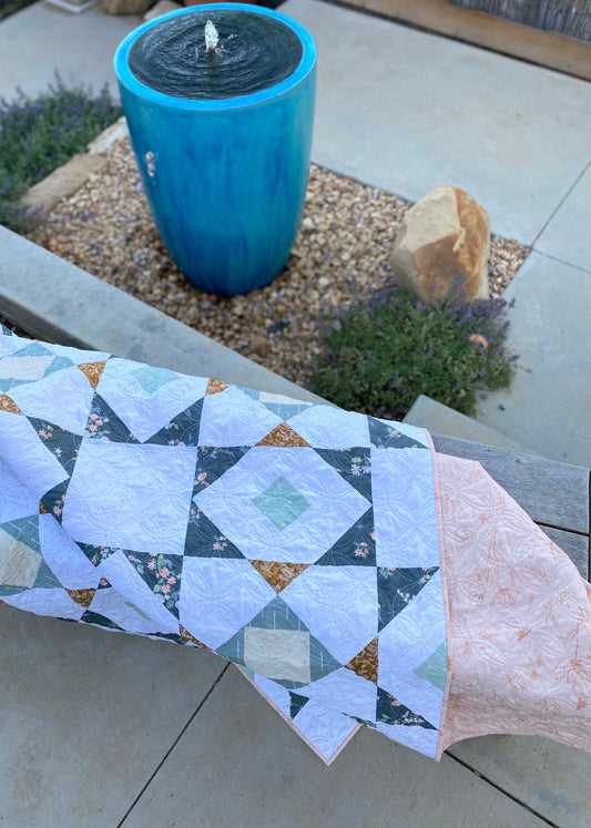 Brightwood Quilt with blue fountain in back